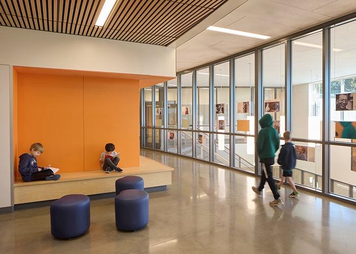 an orange nook and seating with a window area